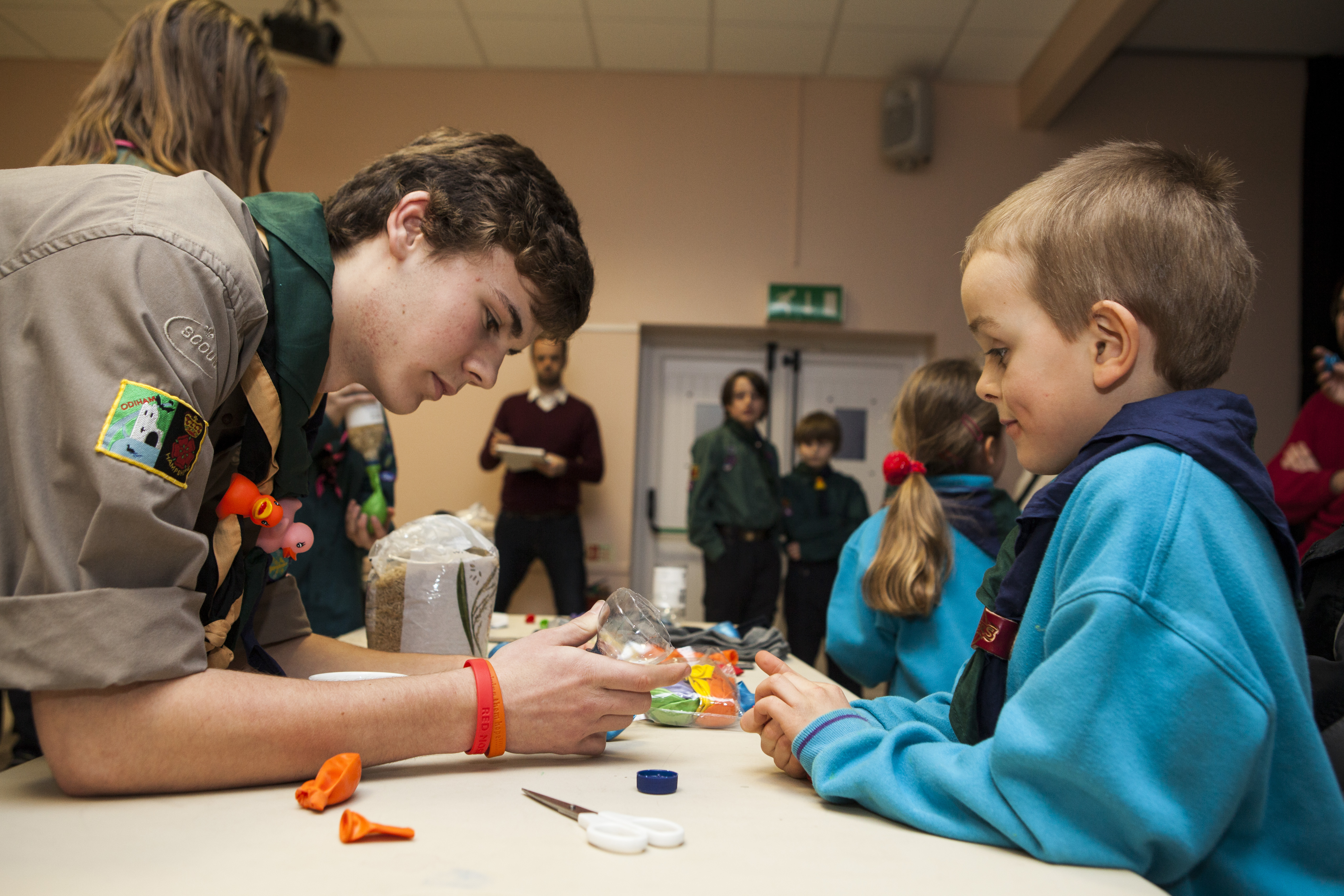 Beavers doing an activity while being helped by young leaders (Stock Scout Image)